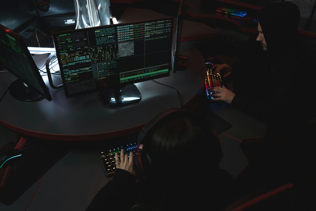Specjaliści IT pracujący przy wielu monitorach z widocznym kodem programistycznym – zaawansowane rekrutacje technologiczne i oferty dla programistów na cvsearch.pl